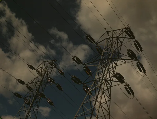 Steel transmission towers and insulators against a cloudy sky, Chickamauga Dam switchyard, Tennessee, 1942